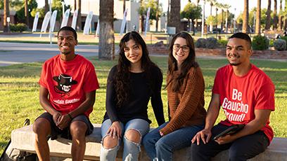 GCC students sitting outside the Business (B) Building on the main campus.