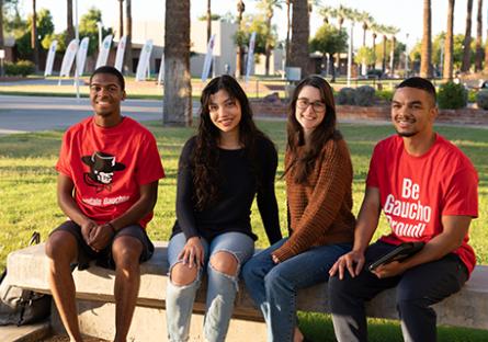 GCC students sitting outside the Business (B) Building on the main campus.