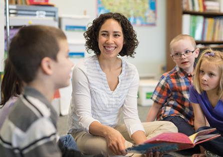 Female teacher reading to students