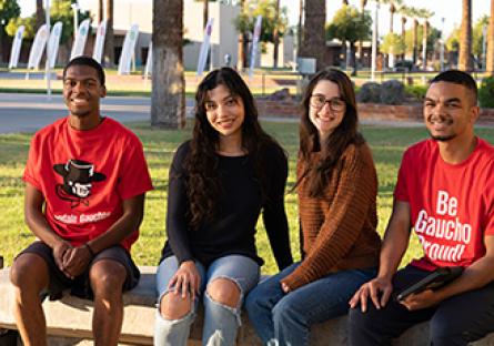 GCC students sitting outside the Business (B) Building on the main campus.
