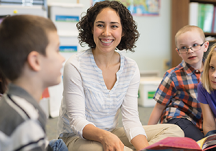 Female teacher reading to students